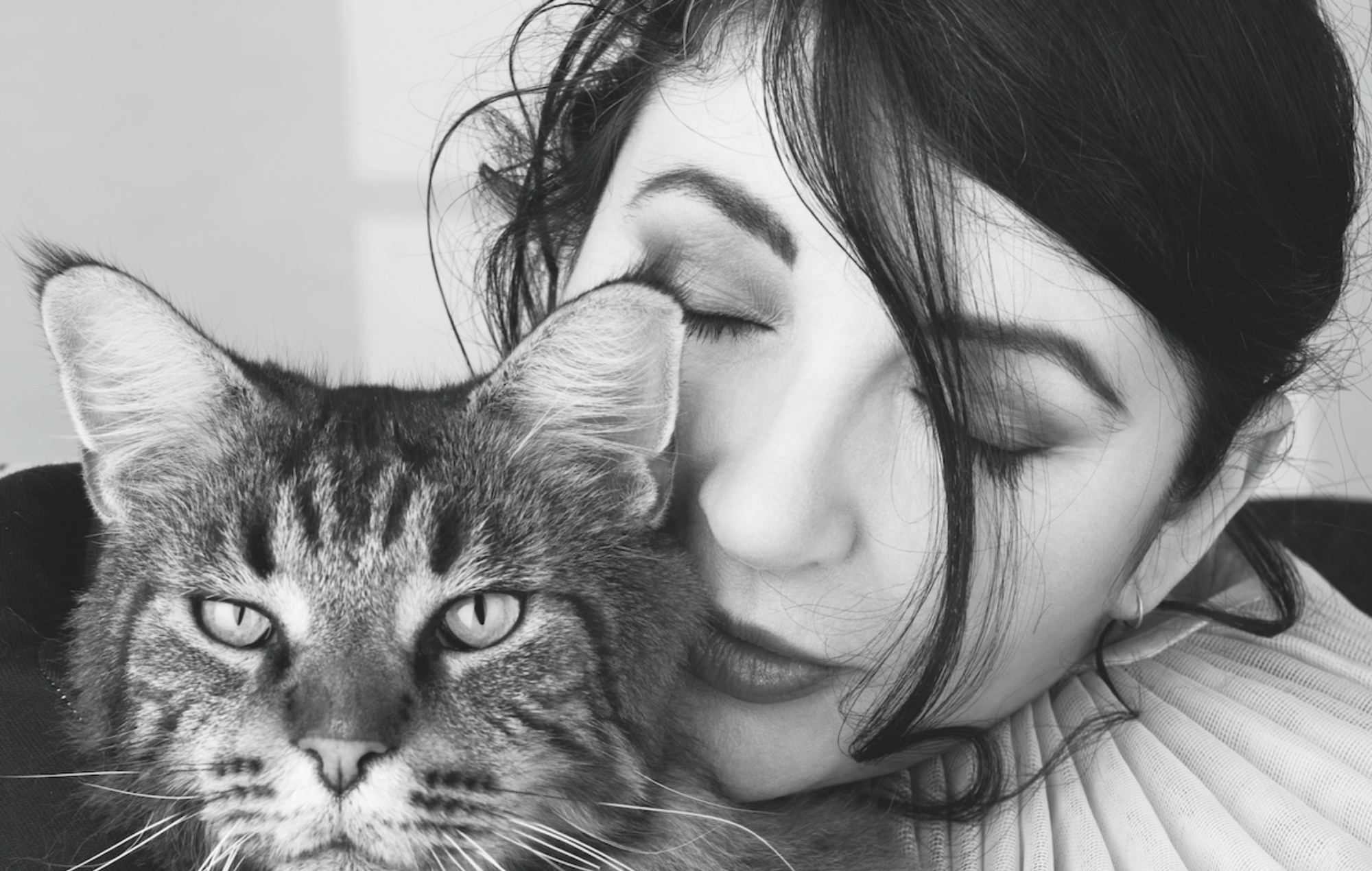 a black and white photo of Kate Bush and a cat