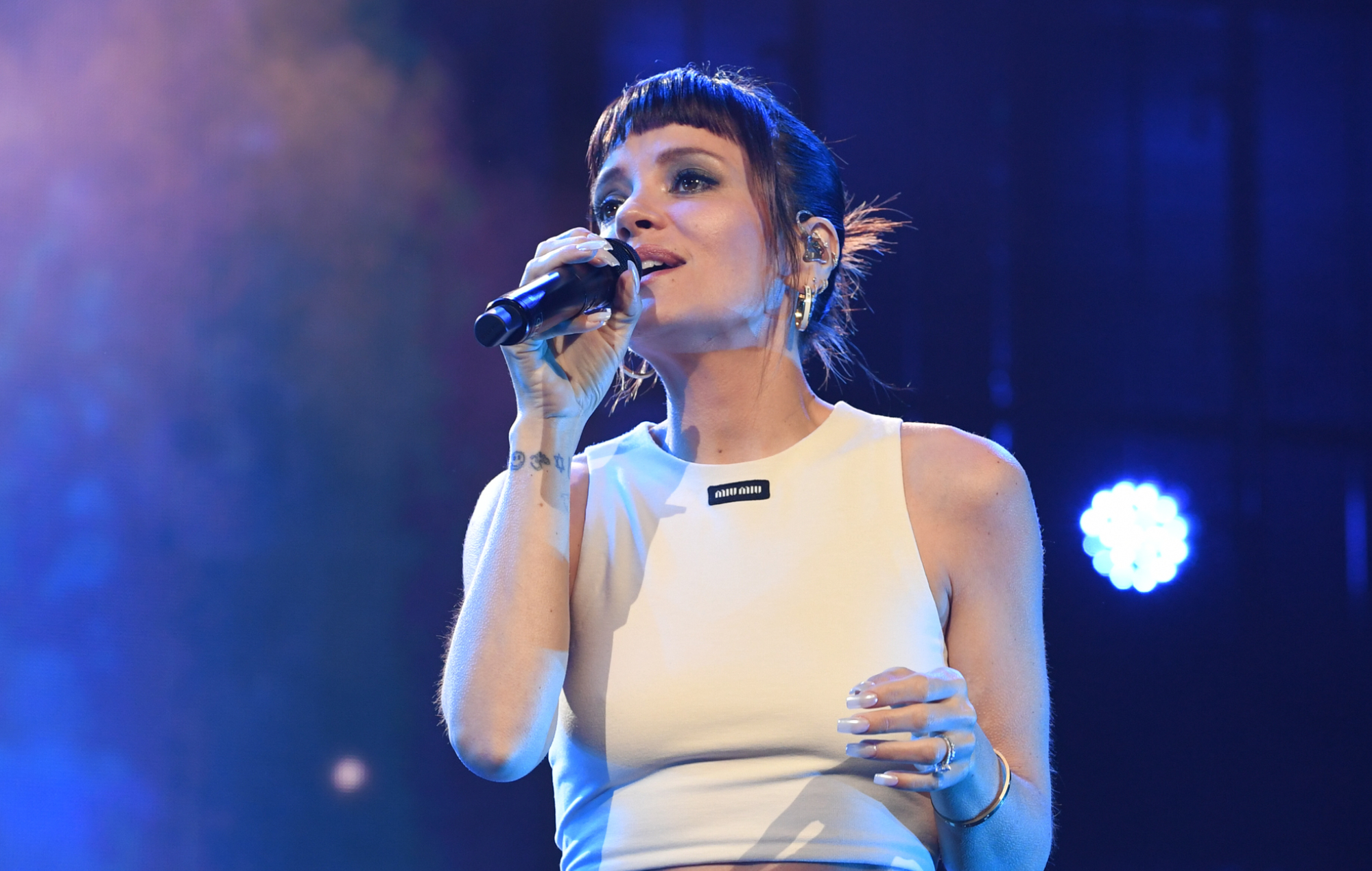 Lily Allen performing live on stage, photo by Nicky J Sims/Getty