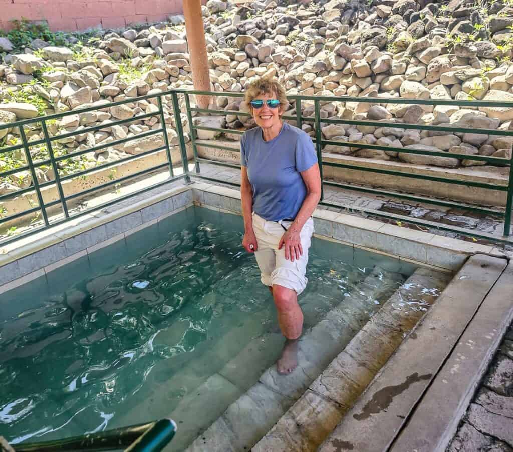 Testing the hot springs temperature at the Bath Hotel & Hot Springs on Nevis