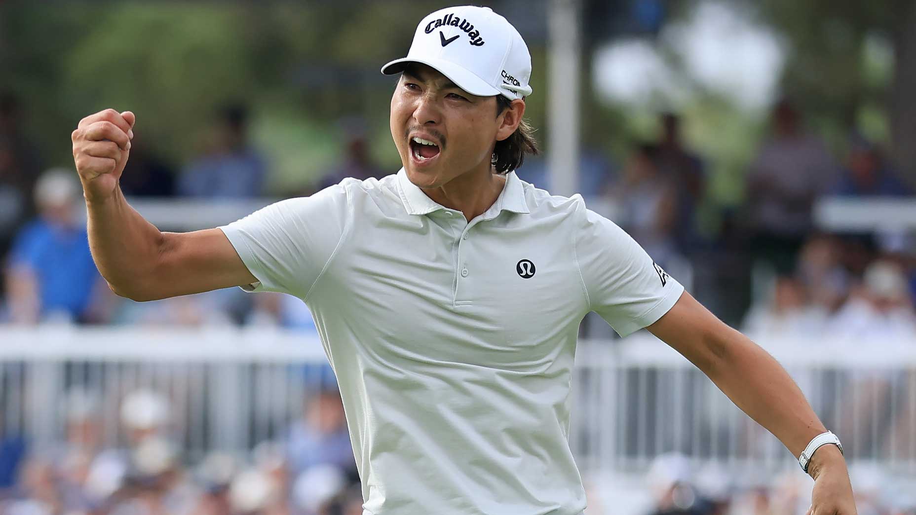 min woo lee fist pumps at the Houston Open in gray shirt and white hat