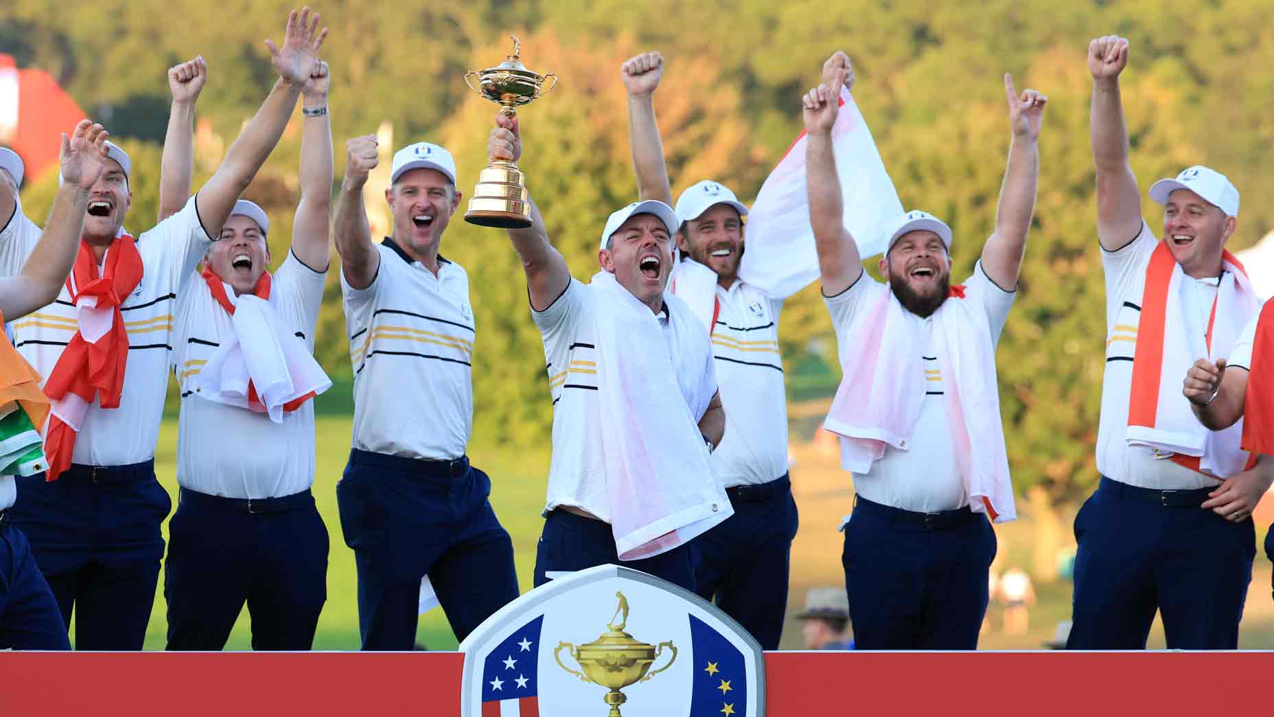 Rory McIlroy of Europe holds the Ryder Cup trophy aloft as Team Europe celebrate their 15-13 victory during the trophy presentation ceremony following the Sunday singles matches of the 2025 Ryder Cup at Black Course at Bethpage State Park Golf Course on September 28, 2025 in Farmingdale, New York.