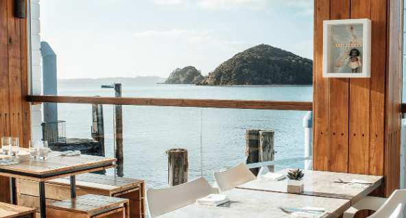 restaurant view of the bay of islands with tables set