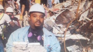 Paul Eliacin remembers the smoke first. Thick. Dark. Unnatural. It filled the air long before the news made it clear what was happening.